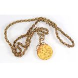 A gold plated ropetwist necklace suspending a sovereign dated 1915 in a fixed mount