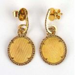 A pair of 18ct yellow gold ear pendants of oval form, each with a vacant central section within a