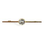 An early 20th century 15ct yellow gold bar brooch set round (?)aquamarine, w. 5.5 cm, 3.5 gms,