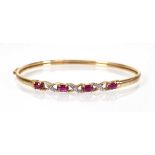 A 9ct yellow gold hinged bracelet set small rubies and diamonds, 4.2 gms