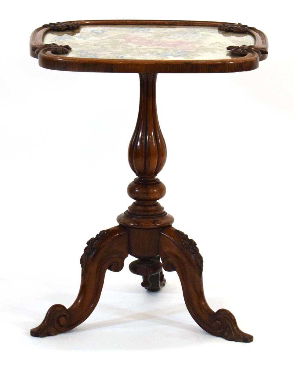A 19th century rosewood occasional table with an embroidered surface on a turned column and three