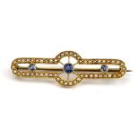 An Edwardian 15ct yellow gold bar brooch set three graduated sapphires and seed pearls in the