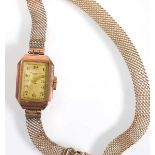 A ladies 9ct yellow gold wristwatch by 'Dot', the rectangular dial with black Arabic numerals on a