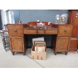 A George III mahogany and ebony strung twin-pedestal sideboard, the superstructure over two drawers,