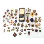 A collection of enamelled badges and medallions including a cased Bedfordshire 'Hand Leather