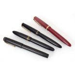 A group of four fountain pens, each with a 14ct gold nib