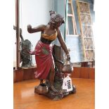 An early 20th century cold-painted spelter figured modelled as a water carrier, h. 28 cm