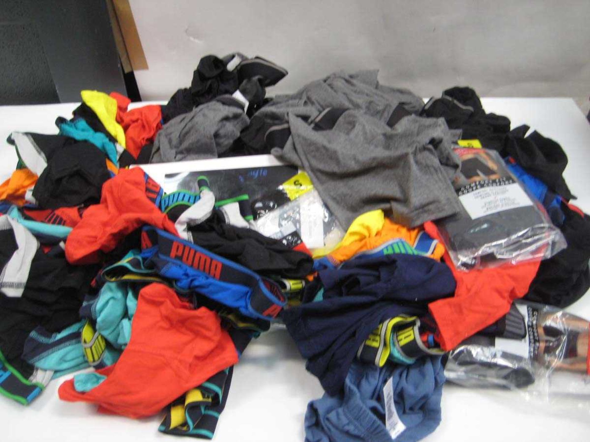 +VAT A bag containing Men's Underwear in various sizes, including Puma, Pringle.