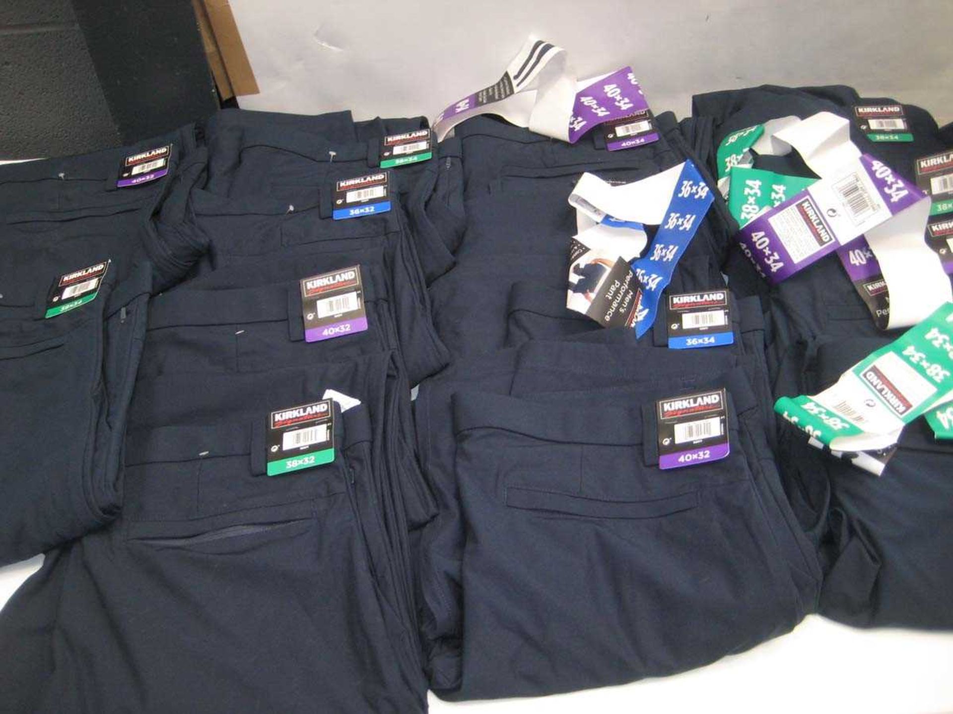 +VAT A bag containing 14x Pairs of Men's Navy Trousers in various sizes.