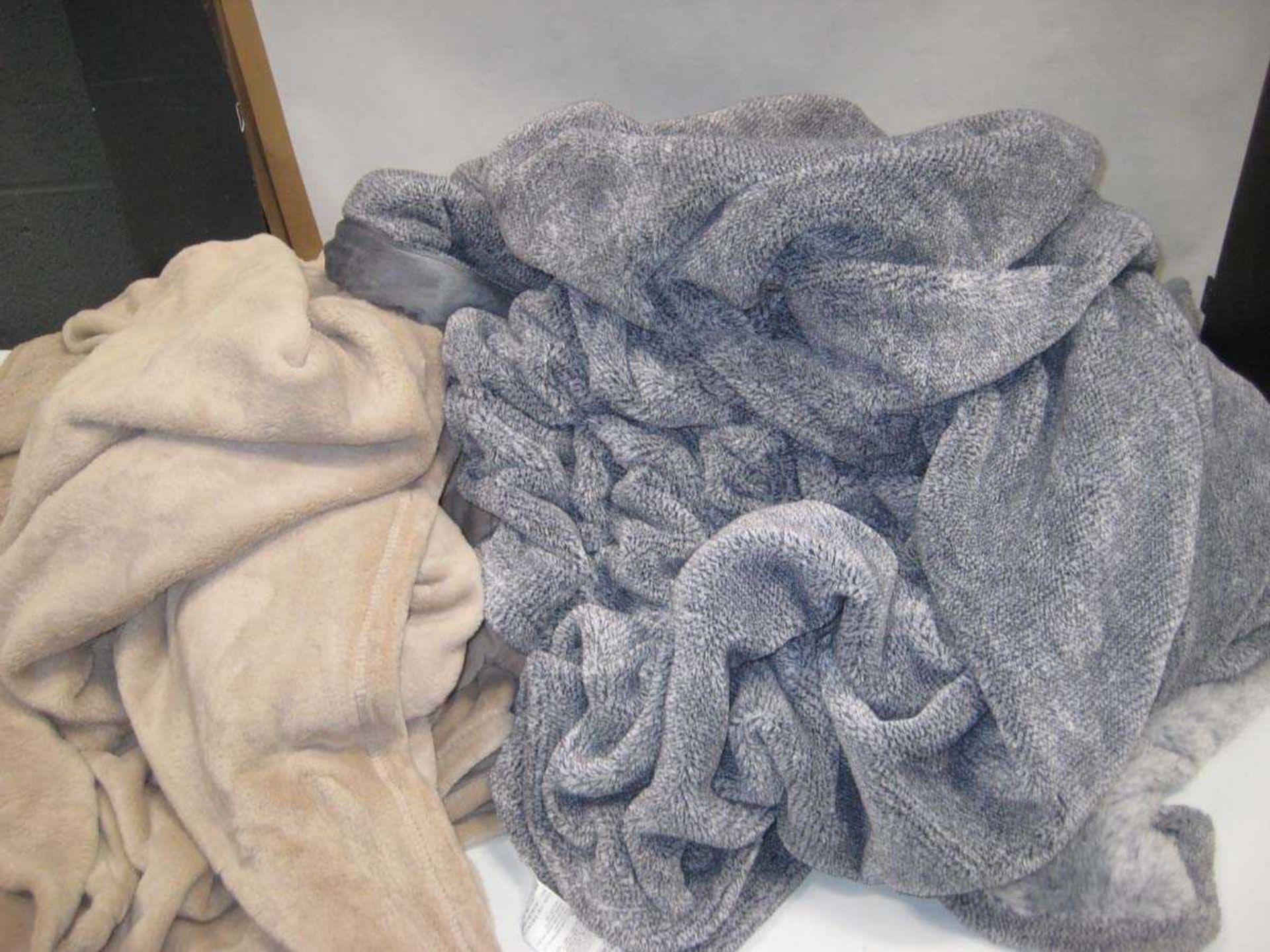 +VAT A bag containing 2x Large Throws in Beige & Grey.