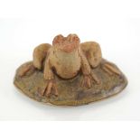 A Bernard Rooke pottery frog seated on a stone, w. 8 cm