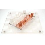 A Modernist acrylic chess set with board, tray and chessmenMinor surface scuffs from use. No