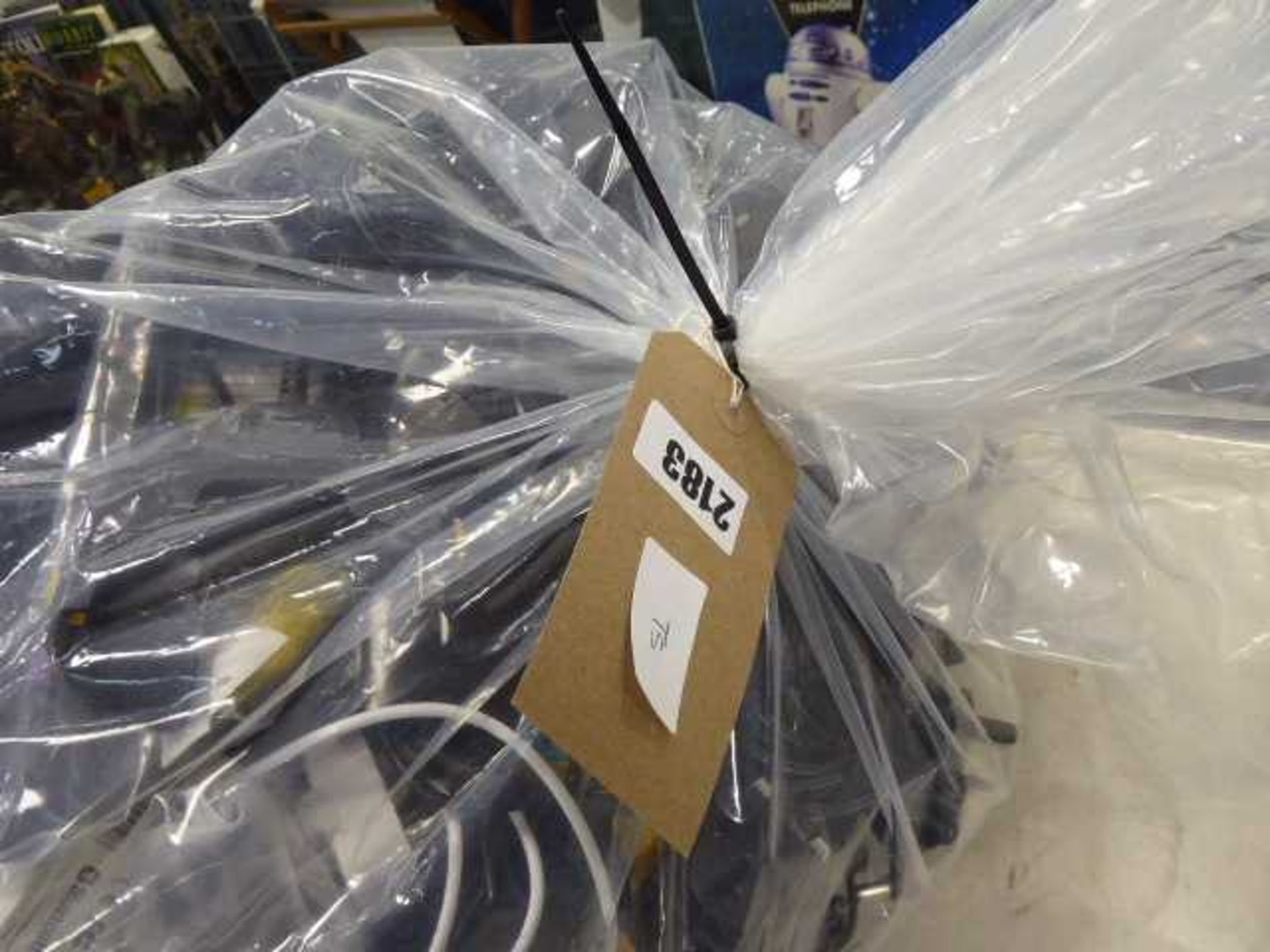 Bag of various electric sundries to include replacement remote controls, apateors, cables etc