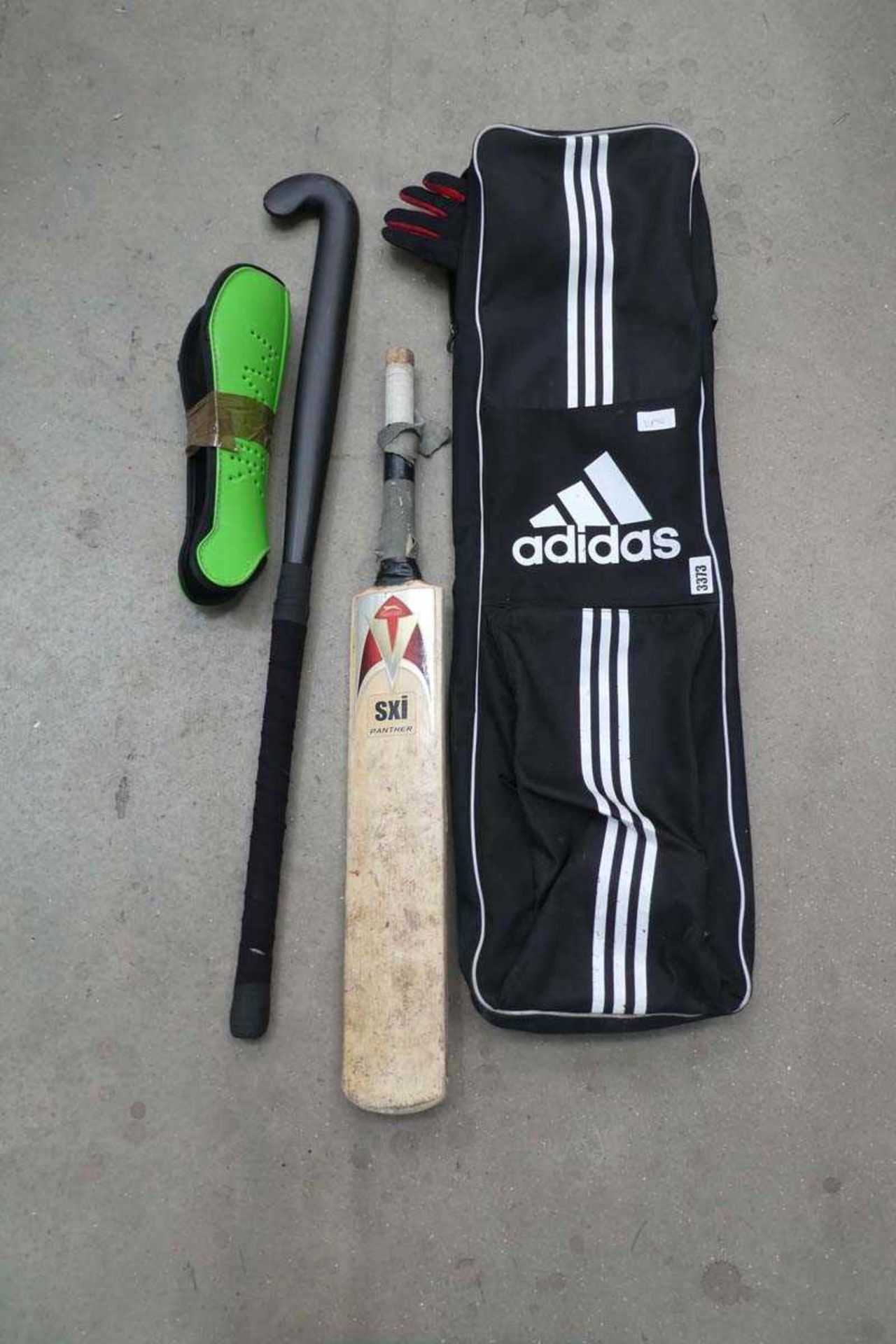 Large cricket shin pads plus an Adidas hockey set to include stick, gloves etc