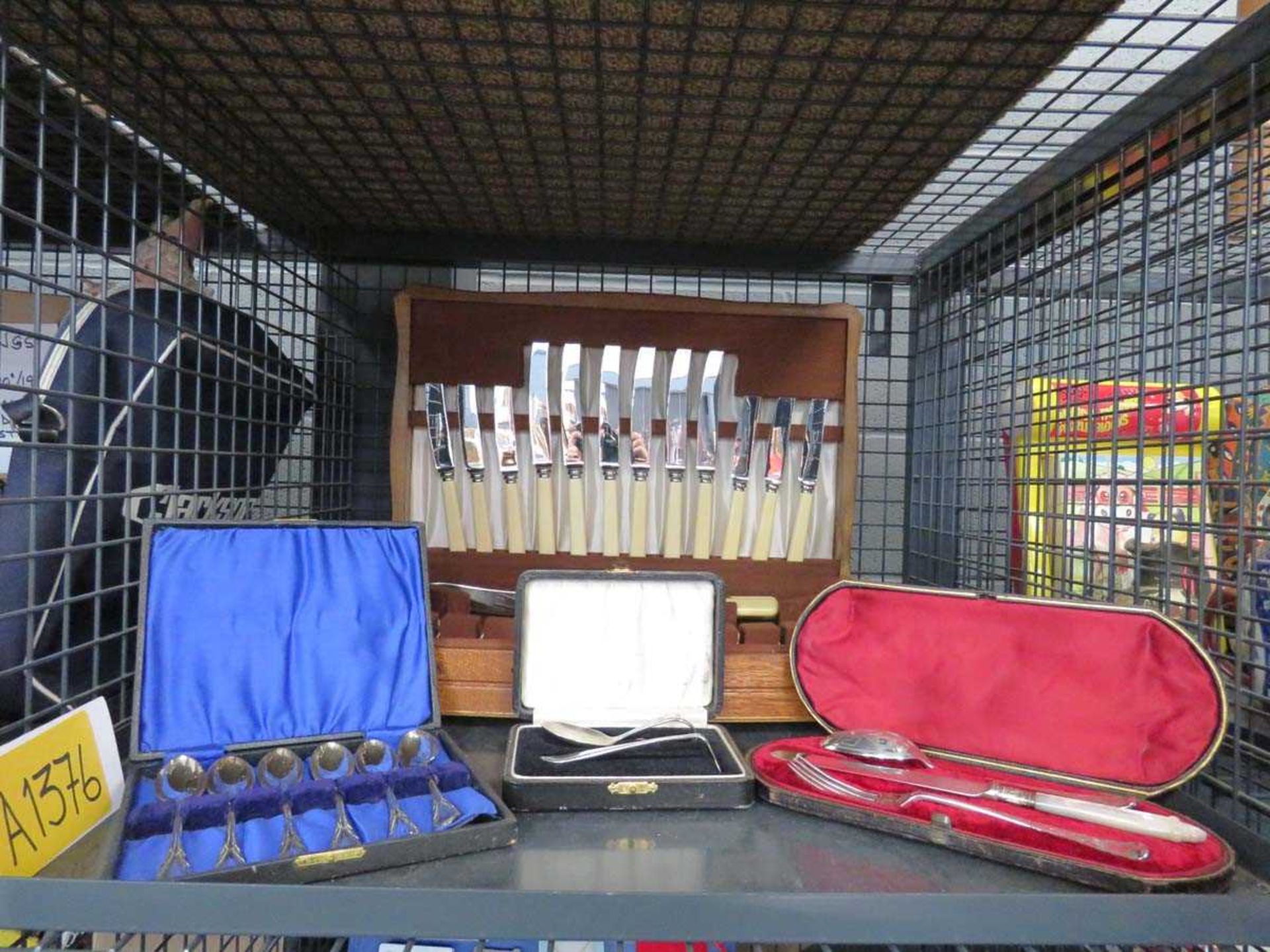 Cage containing cutlery sets