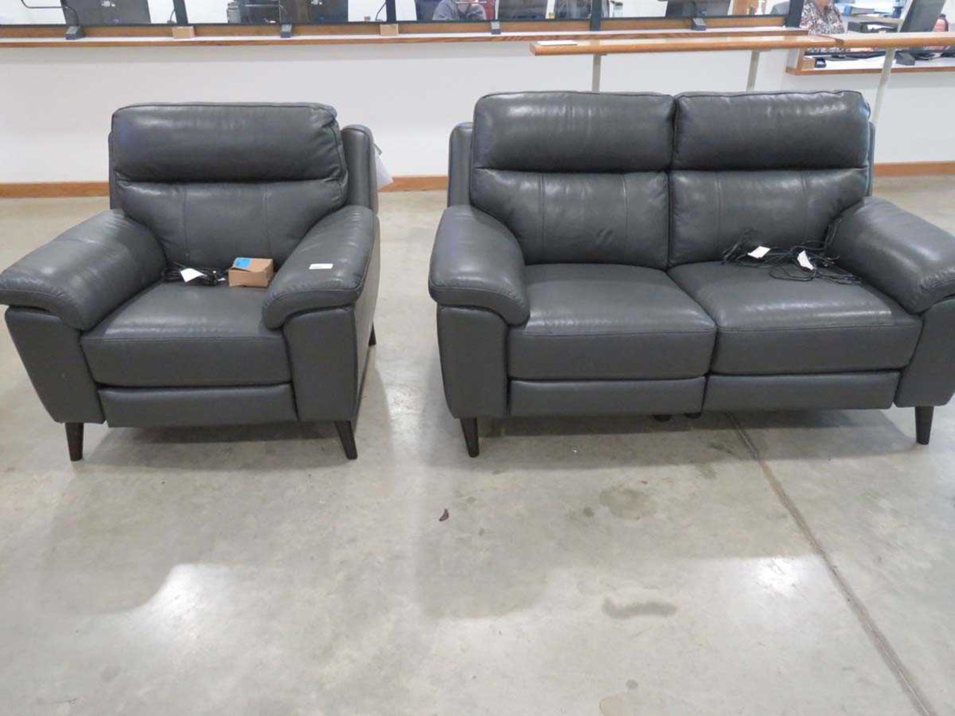 +VAT Grey leather upholstered lounge suite comprising of a 2 seater sofa and matching armchair