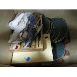 Box containing loose cutlery, placemats and coasters