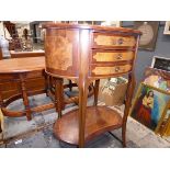 Oval walnut side table with three drawers and shelf under