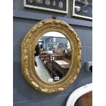 Oval mirror in floral gilt frame