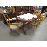 Reproduction yew extending dining table plus four chairs to include two carvers