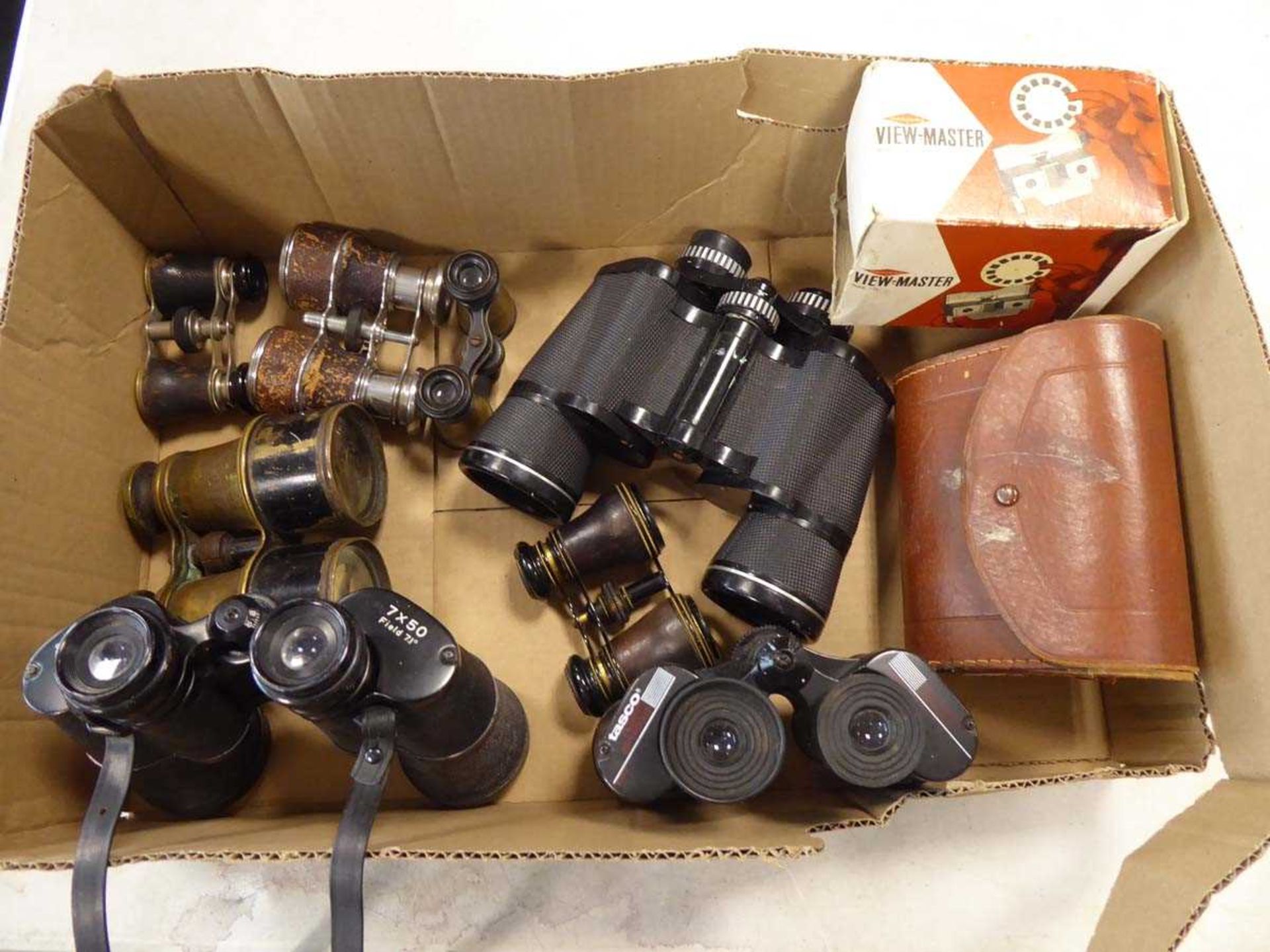 Tray containing various binoculars