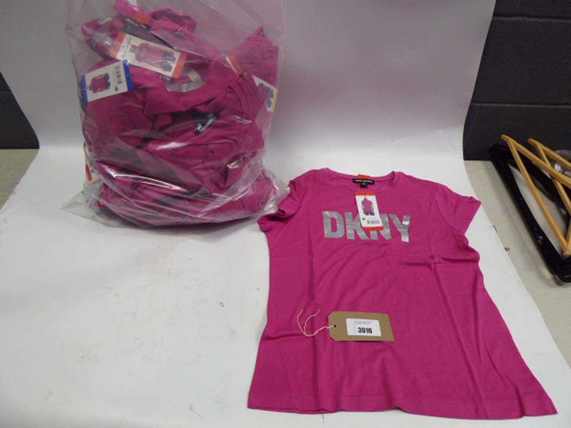 +VAT A bag containing Ladies Pink DKNY T Shirts in various sizes.