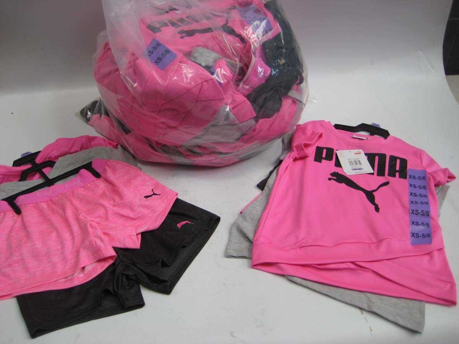 A bag containing approx. 18x sets of Girls Puma Shorts and T Shirts in various sizes.