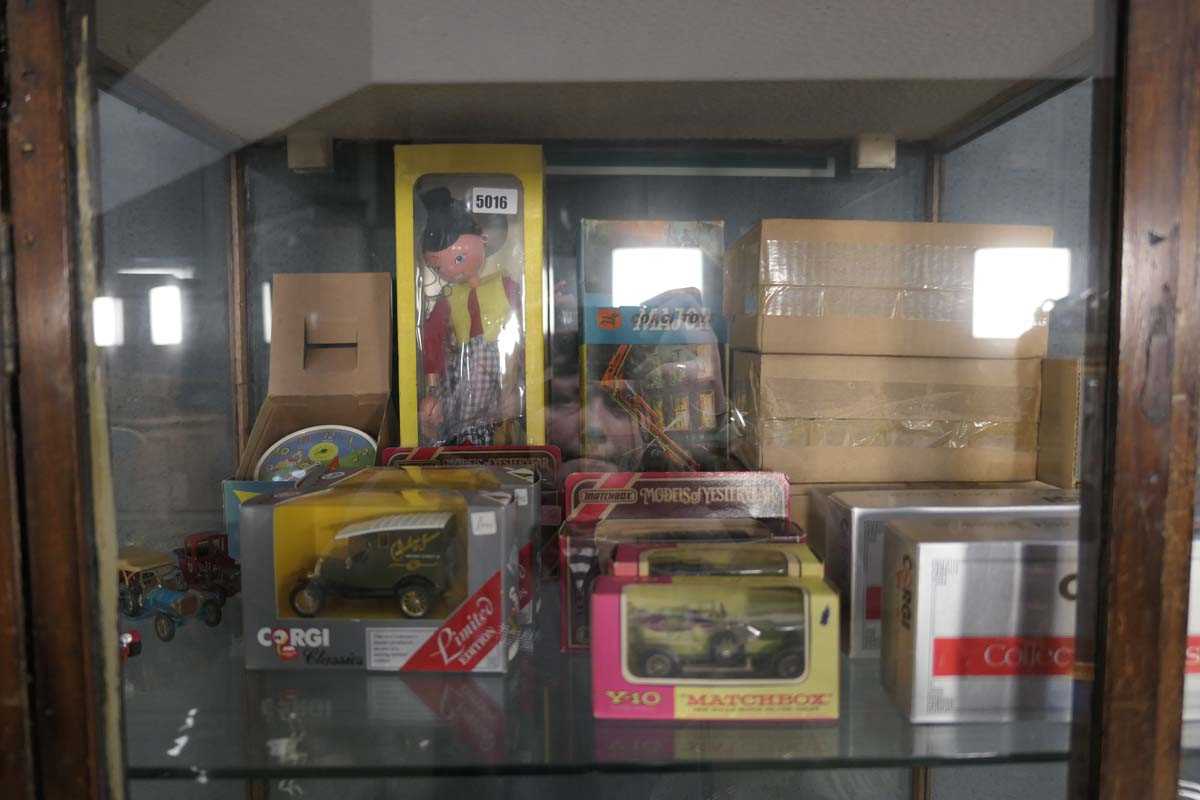 Shelf of vintage children's toys including a Pelham Puppet, die cast vehicles, Corgi fire truck etc