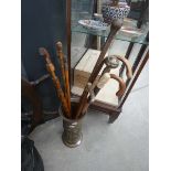 Brass umbrella stand containing 10 various walking sticks