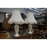 Pair of cream ceramic based table lamps with cream shades