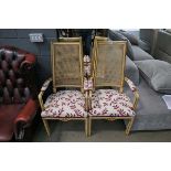 Pair of cane backed armchairs with cream and red floral seats