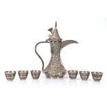 An Omani silver tea/coffee pot repousse decorated in the traditional manner, h. 34.5 cm, together