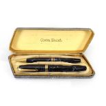 A cased pair of Conway Stewart pens including one with a 14ct gold nib