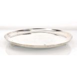 An early 20th century silver salver of plain circular form, Edward Barnard & Sons Ltd., London 1936,