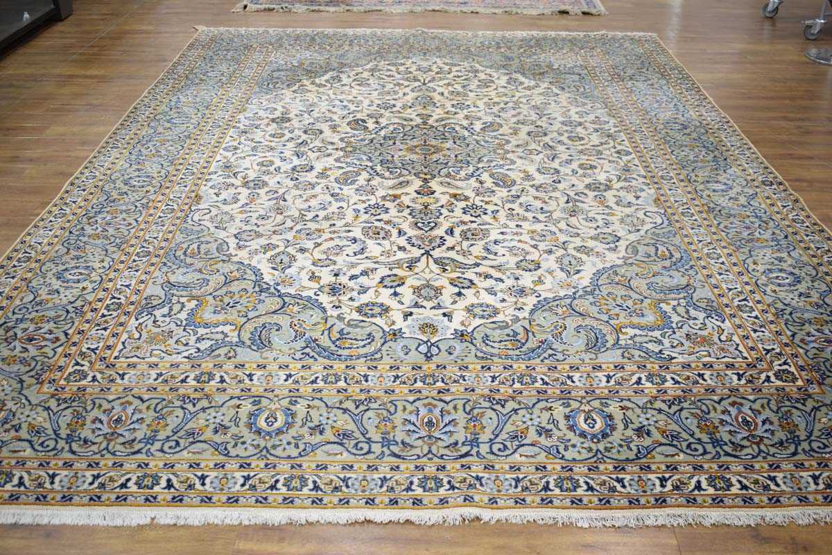 A Persian Kashen carpet, the cream ground intricately decorated with floral sprays within matching
