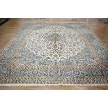 A Persian Kashen carpet, the cream ground intricately decorated with floral sprays within matching