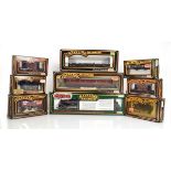 A Mainline Railways OO gauge loco and tender and thirteen items of rolling stock, all boxed (14)