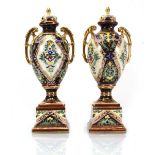 A pair of Noritake two handled vases and covers, each gilt decorated with multi coloured foliate