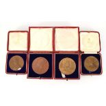 A cased 1897 Diamond Jubilee bronze medal by G.W. de Saulles, together with three cased Coronation