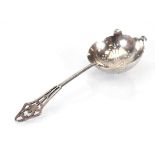 An early 20th century silver straining spoon, the handled pierced in the Neo-Classical manner,