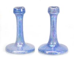 A near pair of Ruskin Pottery candlesticks with aqua lustre glazes, impressed marks, one dated 1925,