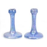 A near pair of Ruskin Pottery candlesticks with aqua lustre glazes, impressed marks, one dated 1925,