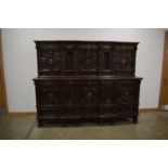 A 1920/30's oak court cupboard decorated with mother-of-pearl floral motifs, the body with an