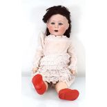 A fully jointed bisque headed doll with blue glass eyes and open mouth, head stamped 'Jutta 1914