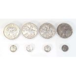 A small group of coins including a 1922 Liberty dollar, two 1935 crowns, a Southern Rhodesian 1953
