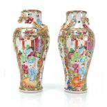 A pair of Cantonese vases of baluster form, typically decorated in coloured enamels with court