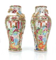 A pair of Cantonese vases of baluster form, typically decorated in coloured enamels with court