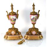 A pair of late 19th century Continental clock garnitures with brass mounts, on matching stands, h.