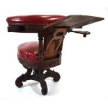 A 19th century carved oak and red leather upholstered 'cockfighting' or reading chair with book rest