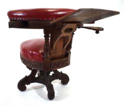 A 19th century carved oak and red leather upholstered 'cockfighting' or reading chair with book rest